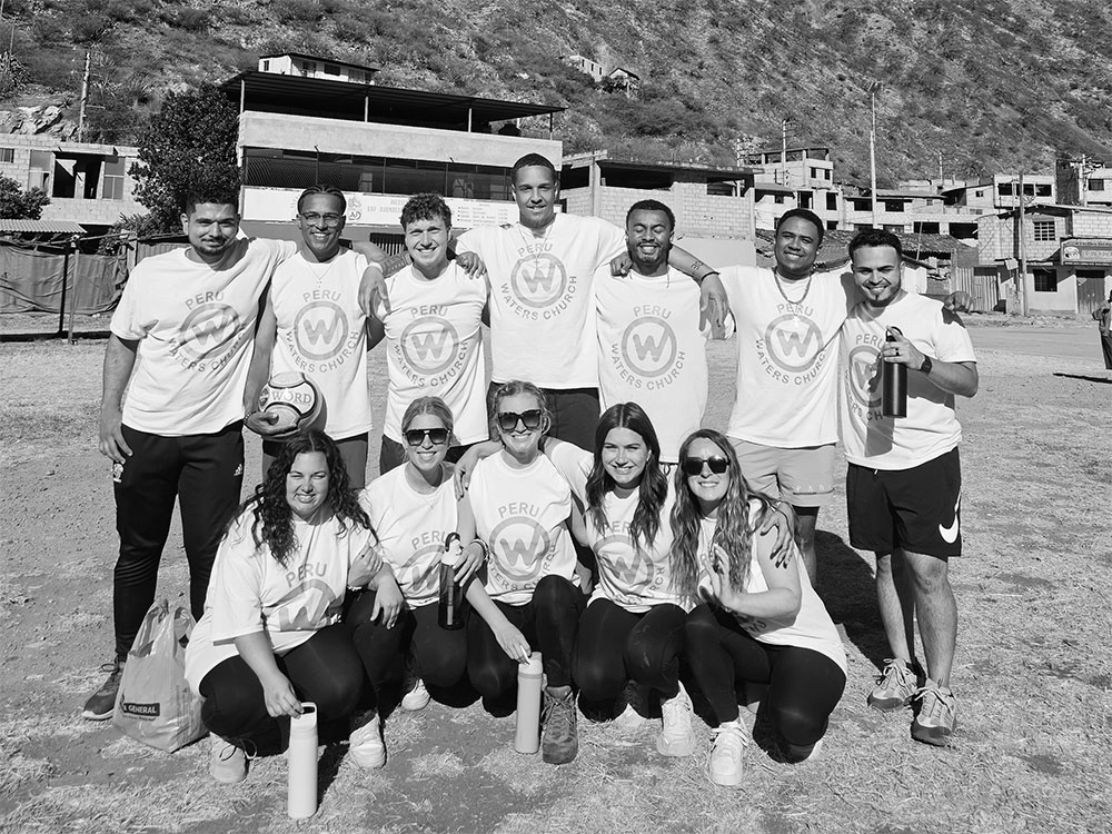 A mission team posing outdoors in matching Peru shirts