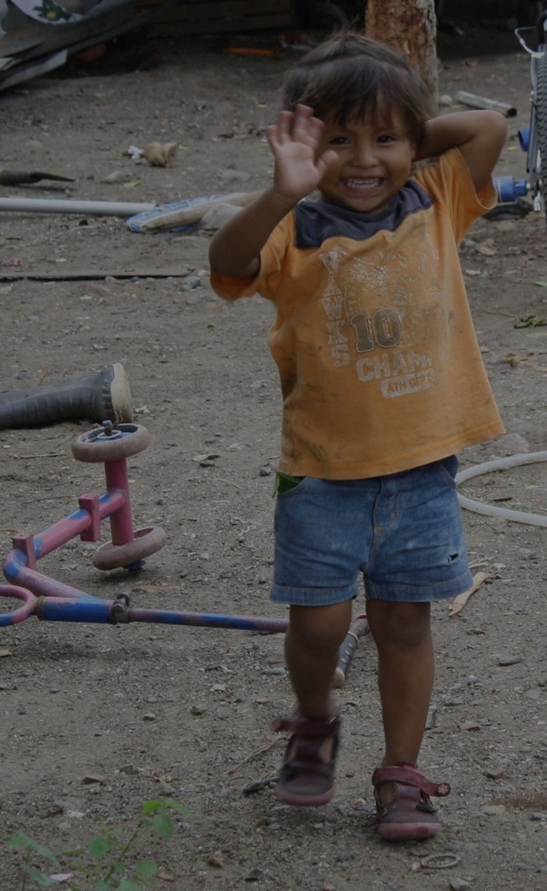 A child waving during Let Love International’s work in Guatemala