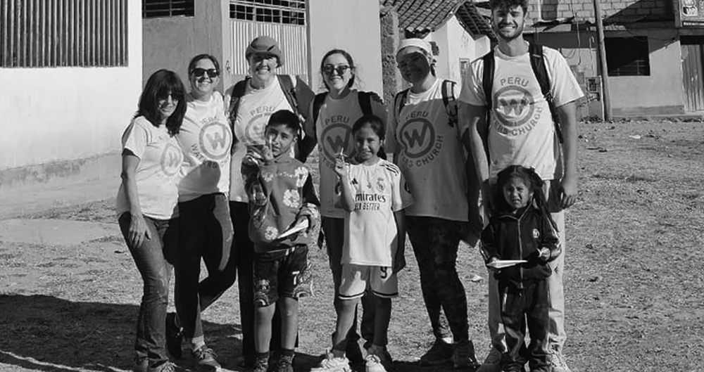 Adults and children standing together outside a building